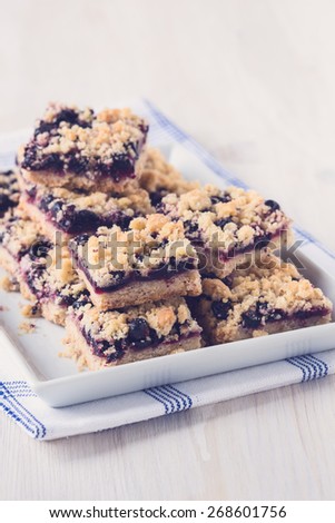 Homemade currant cornmeal crumble bars with streusel topping, healthy sweet dessert, pastel tones