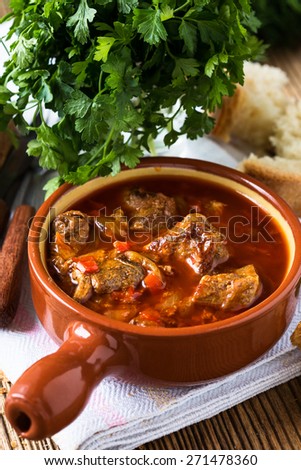 Meat stew in ceramic pot. Traditional Hungarian goulash