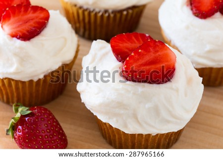 Homemade strawberry cupcakes with whipped cream topping