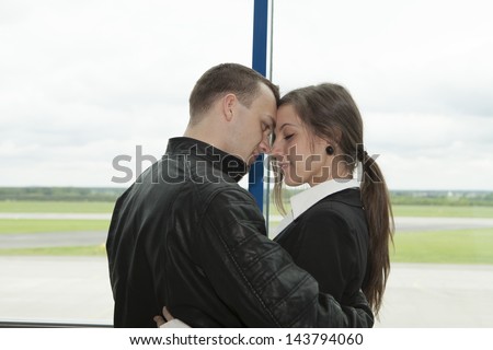 Two embracing people waiting on a plane