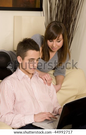 Young couple surfing the net at home