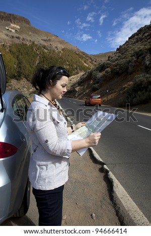 woman looking for a road on the map