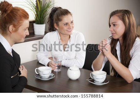 Colleagues drinking coffee during their office break