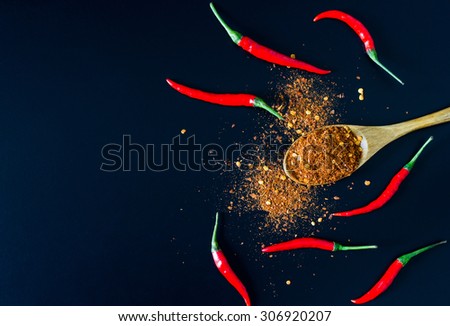 Chili Powder and fresh chili on black background