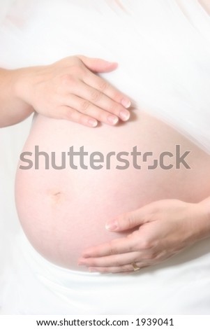 Pregnant woman with hands on stomach