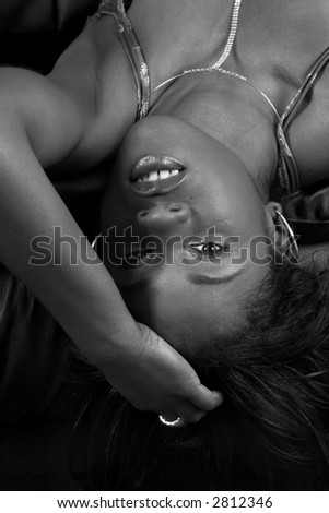 black and white of sexy girl leaning back over couch