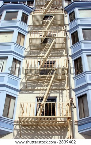 fire escapes on blue and white building