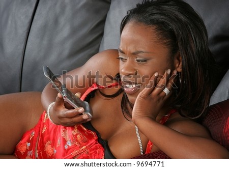 pretty black girl looking confused at cell phone