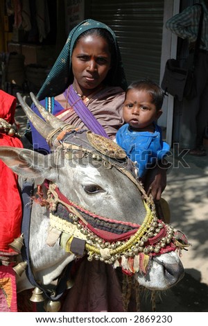 Tribal woman with baby and nandi bull