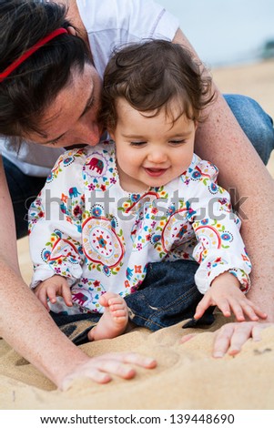 An infant and Mummy enjoy a special moment at the beach