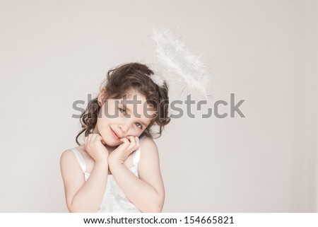 A little girl enjoying her angel halo and outfit at Christmas