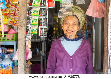 Ubud, Indonesia - September 2: An unidentified elderly woman at a roadside store selling food near Ubud, Bali, Indonesia on September 2nd 2014.