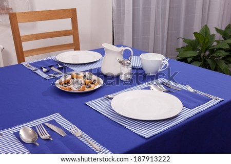 laid table/ fork and spoon laid on blue cloth in the kitchen