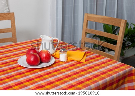 laid table/ fork and spoon laid on red cloth in the kitchen