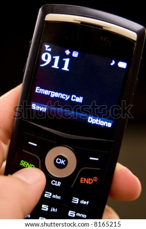 A slim cell phone in hand ready to dial 911 in an emergency situation.
