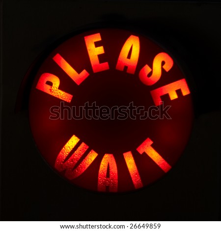 A Please Wait Sign Illuminated in Red
