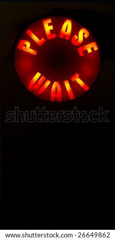 A Please Wait Sign Illuminated in Red with room below.