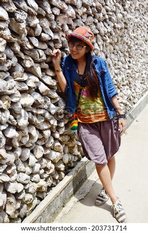 Thai women portrait with Oyster Shell wall in Wat Chedi Hoi, The Oyster Shell Temple located in of Pathum Thani Province, central Thailand.