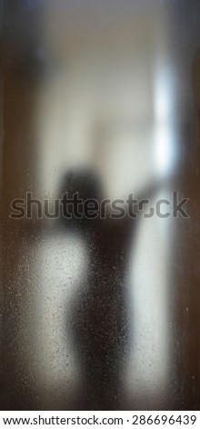 Shadow woman blur nude with water grain on mirror plate Backgrounds of bathroom