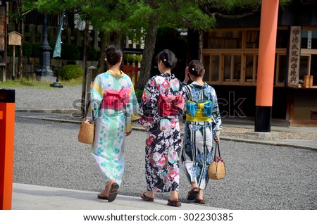 KYOTO, JAPAN - JULY 11 : Japanese people wear traditional Japanese clothing (Kimono and Yukatas) walking to inside at Fushimi Inari Shrine on July 11, 2015 in Kyoto, Japan