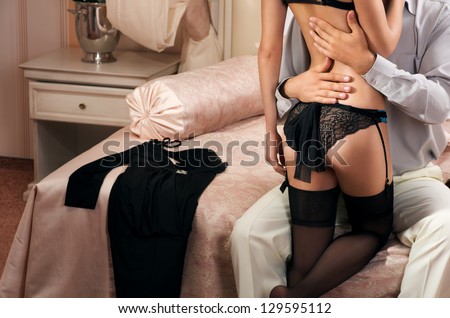 Sexy Woman In Lingerie With Man In Bedroom