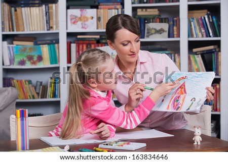 Child Psychologist With A Little Girl, A Child Draws
