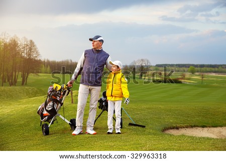 Father with son are training at golf course
