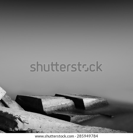 black & white daytime long exposure rocky seascape scene with stones and water. Black sea, Odessa, Ukraine