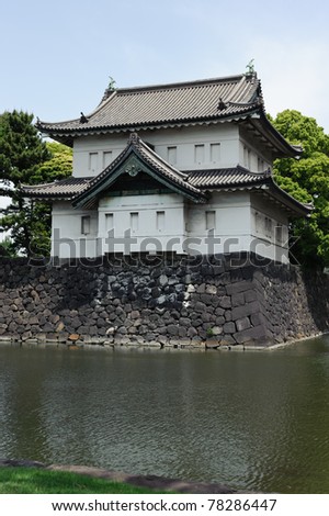 Imperial guardhouse over the moat surrounding the Imperial Palace of Tokyo, Japan, in vertical