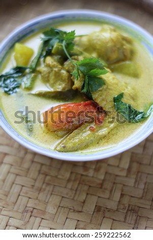 Ayam Masak Lemak- Traditional Malay Cuisine. Chicken cook with tumeric herbs, coconut milk, spices and tomatoes