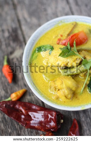 Ayam Masak Lemak- Traditional Malay Cuisine. Chicken cook with tumeric herbs, coconut milk, spices and tomatoes