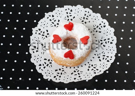 Doughnut with icing sugar and love shape sugar on top