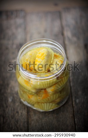 Pineapple tart in jar with wooden background