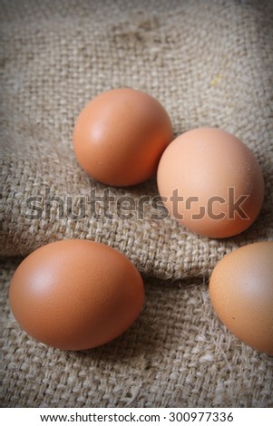 Fresh eggs with brown sack background. Country living concept