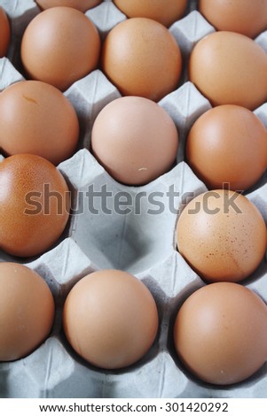 Eggs in a tray and one egg red in color. Easter theme egg