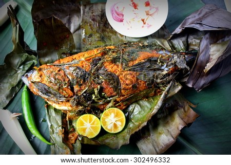 Ikan Bakar - Malaysian famous street food. Grill fish wrapped in banana leaf with a lots of spices.