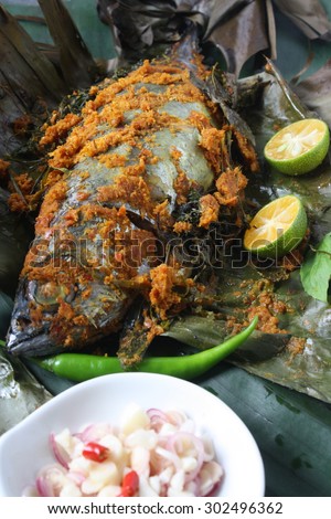 Ikan Bakar - Malaysian famous street food. Grill fish wrapped in banana leaf with a lots of spices.
