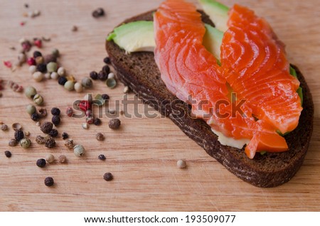 black bread with red fish and avocado