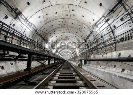 straight circular subway tunnel with a white lighting