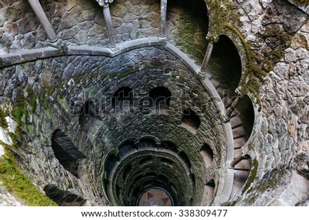 Initiation Wells. Deep well in the territory of Quinta da Regaleira. Old spiral staircase goes down