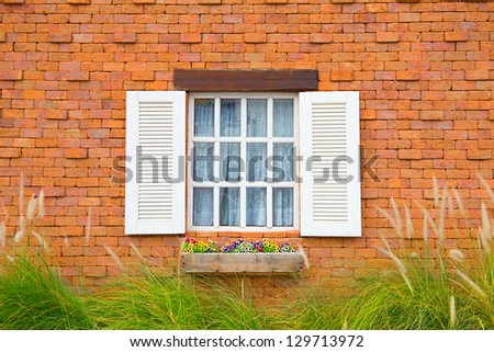 The white window with flower box and shutters