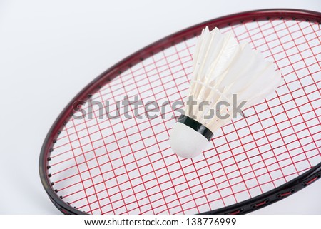 Badminton ball on badminton racket with white background