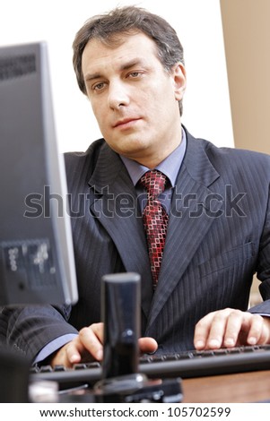 Middle aged businessman working at computer in office