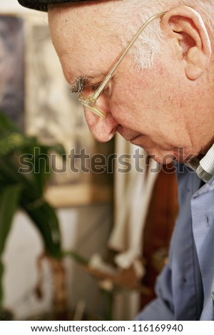 Senior man at work closeup photo profile view