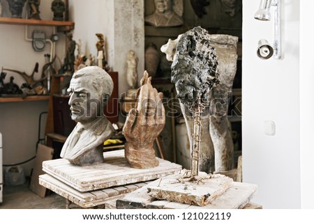 Various sculptures and statues in studio interior