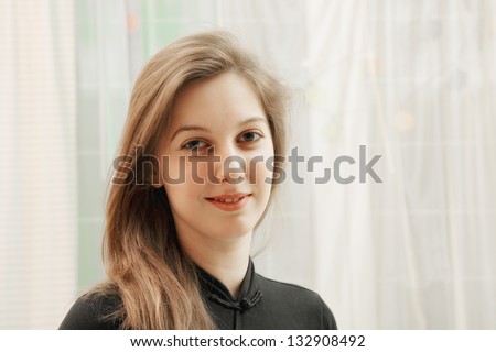 Portrait of positive young caucasian woman in black shirt