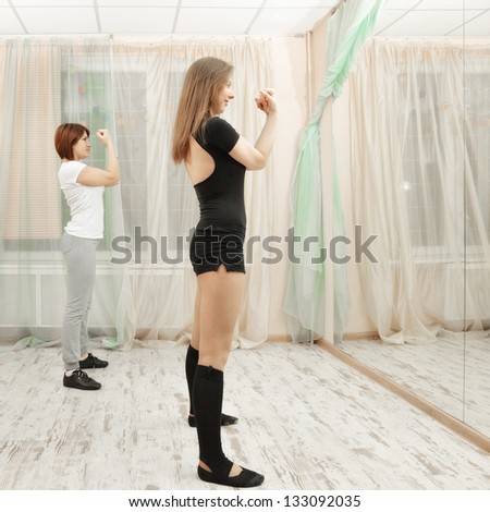 Group fitness exercises in front of the mirror