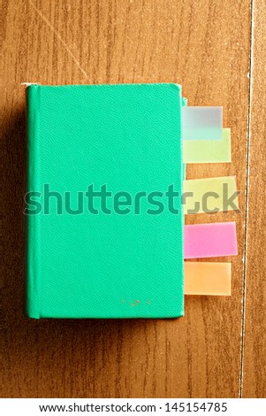 Green book with bookmarks above view