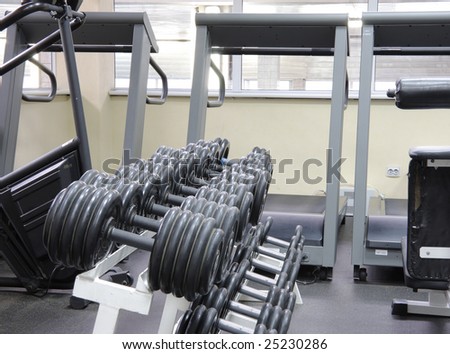 Weights rack with treadmills row on background indoor photo