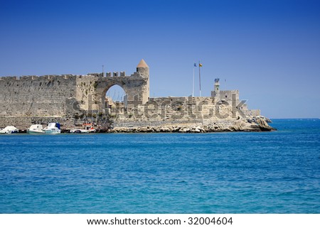 Old pier in Rhodes with ships parked on a front stage